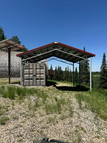 View of parking with a detached carport