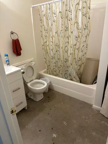 Bathroom featuring shower / bathtub combination with curtain and vanity