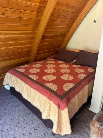 Carpeted bedroom with wood ceiling