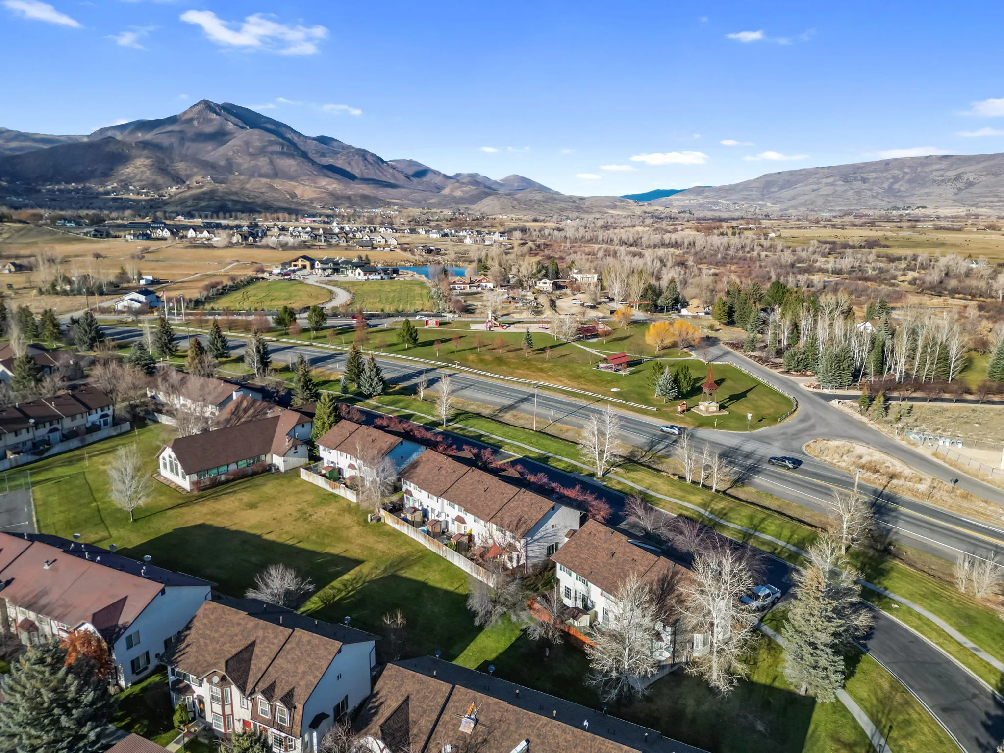 Aerial overview of property's location with a mountain backdrop and nearby suburban area