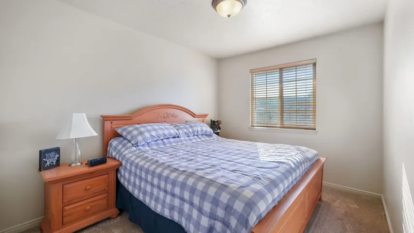 Bedroom with a textured ceiling and carpet flooring