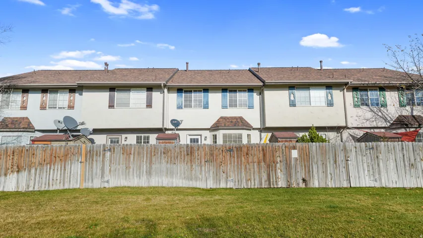 Back of property featuring stucco siding and a fenced backyard