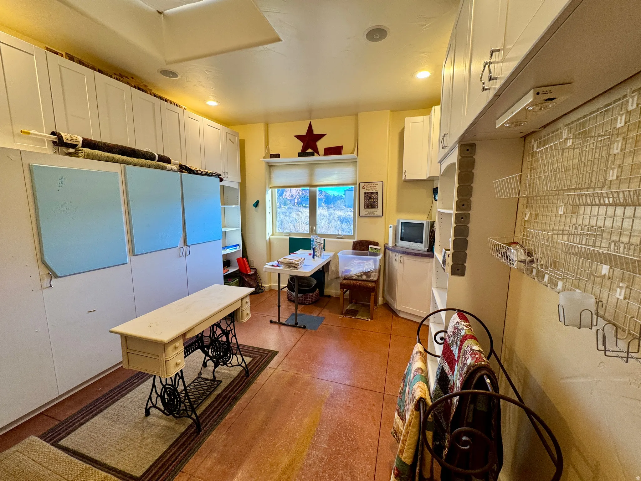Kitchen featuring white cabinetry and recessed lighting