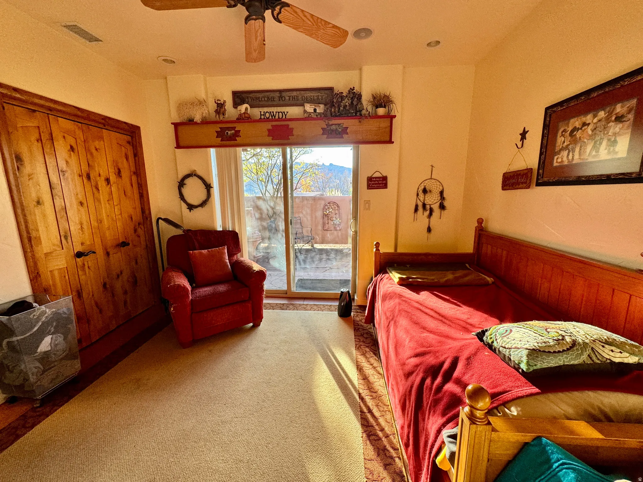 Carpeted bedroom with access to outside and ceiling fan