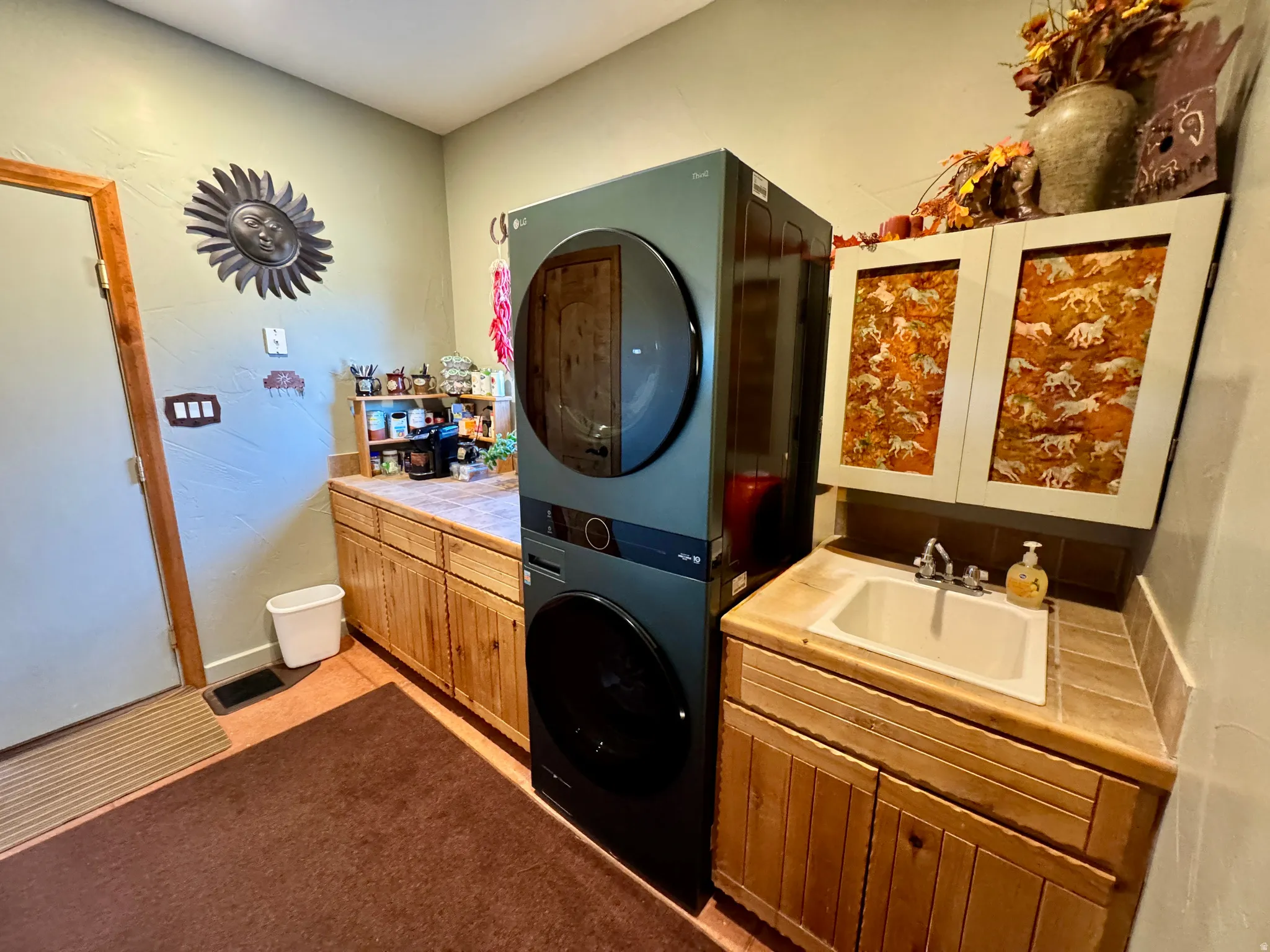 Bathroom featuring stacked washing machine and dryer and vanity
