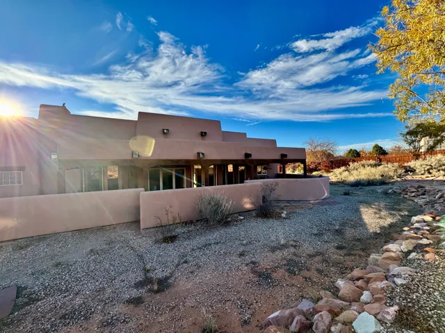 Rear view of house featuring stucco siding
