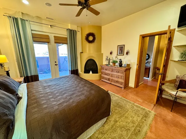 Bedroom featuring french doors, access to outside, and ceiling fan