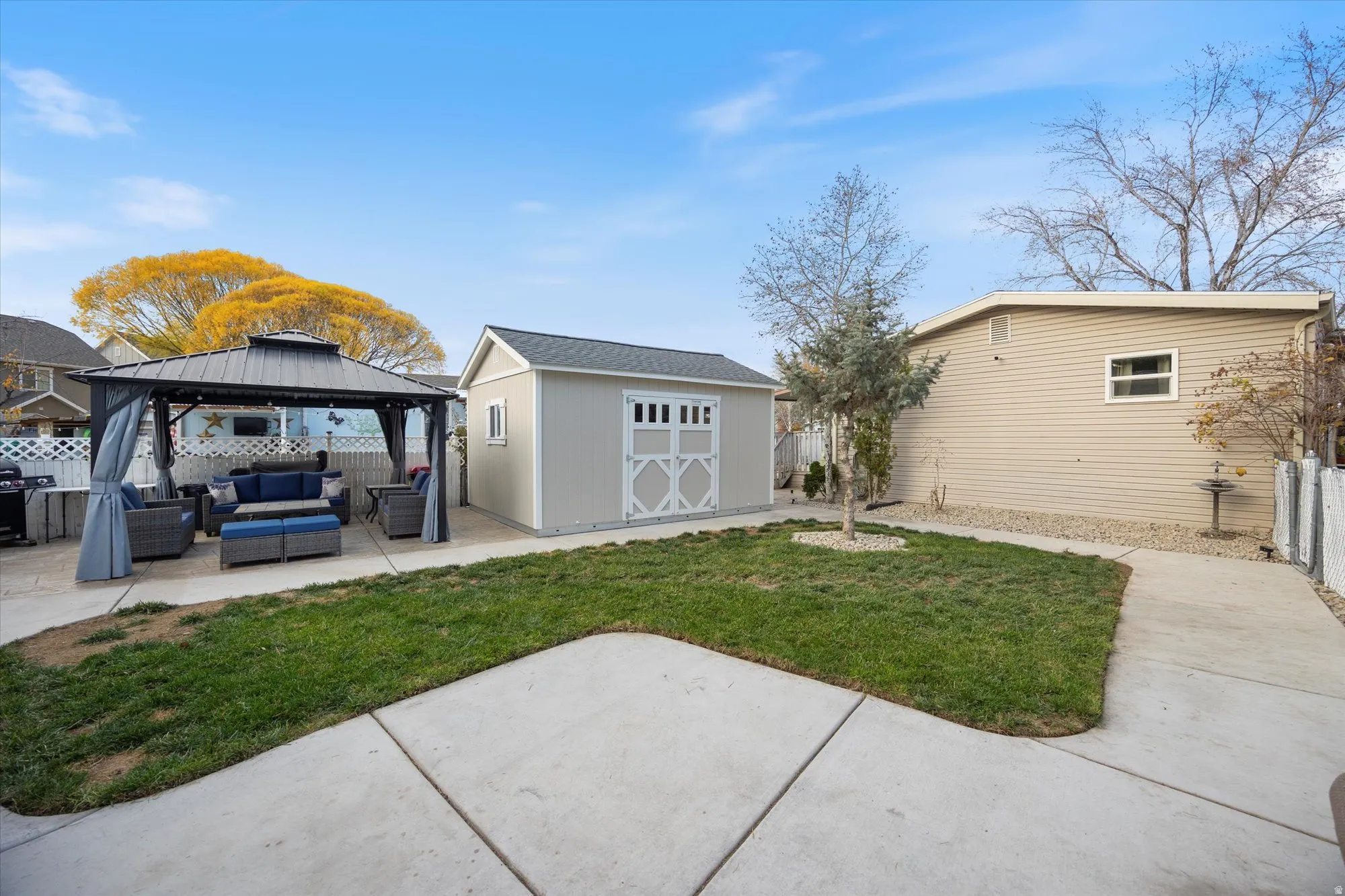 Back of house with an outdoor hangout area, a gazebo, a patio, and a fenced backyard