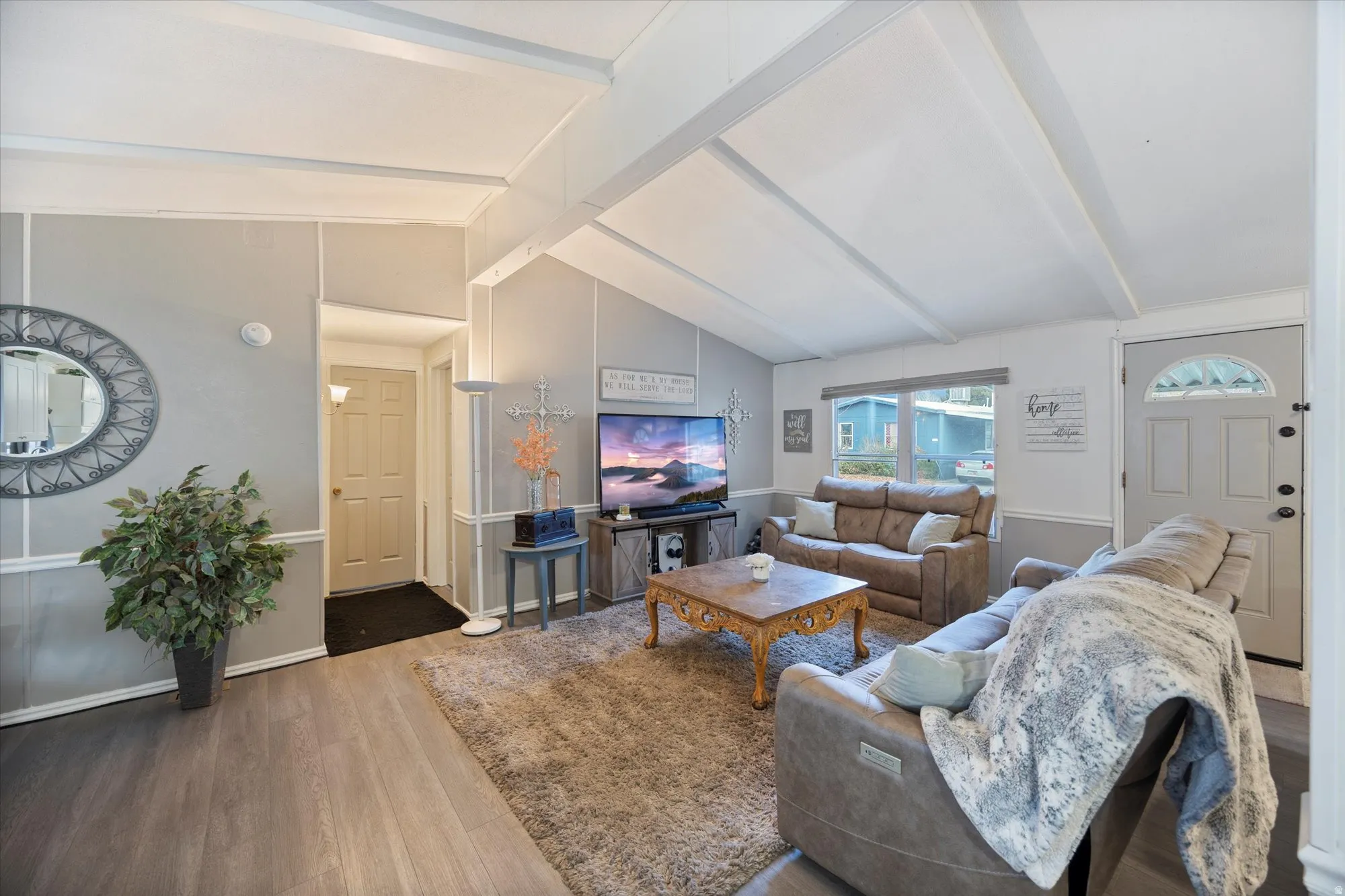 Living area with wood finished floors and baseboards