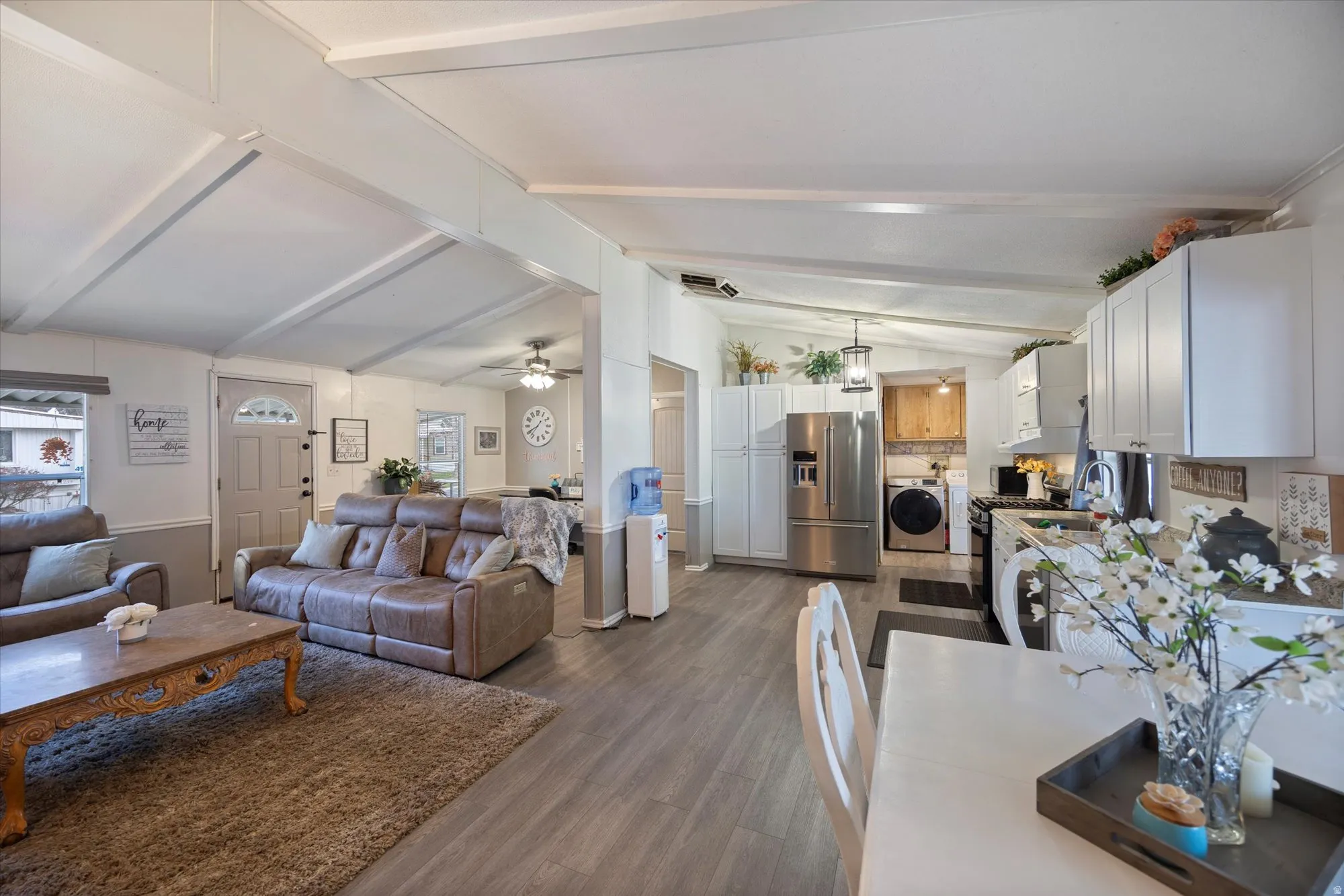 Living area with dark wood finished floors and washer / clothes dryer