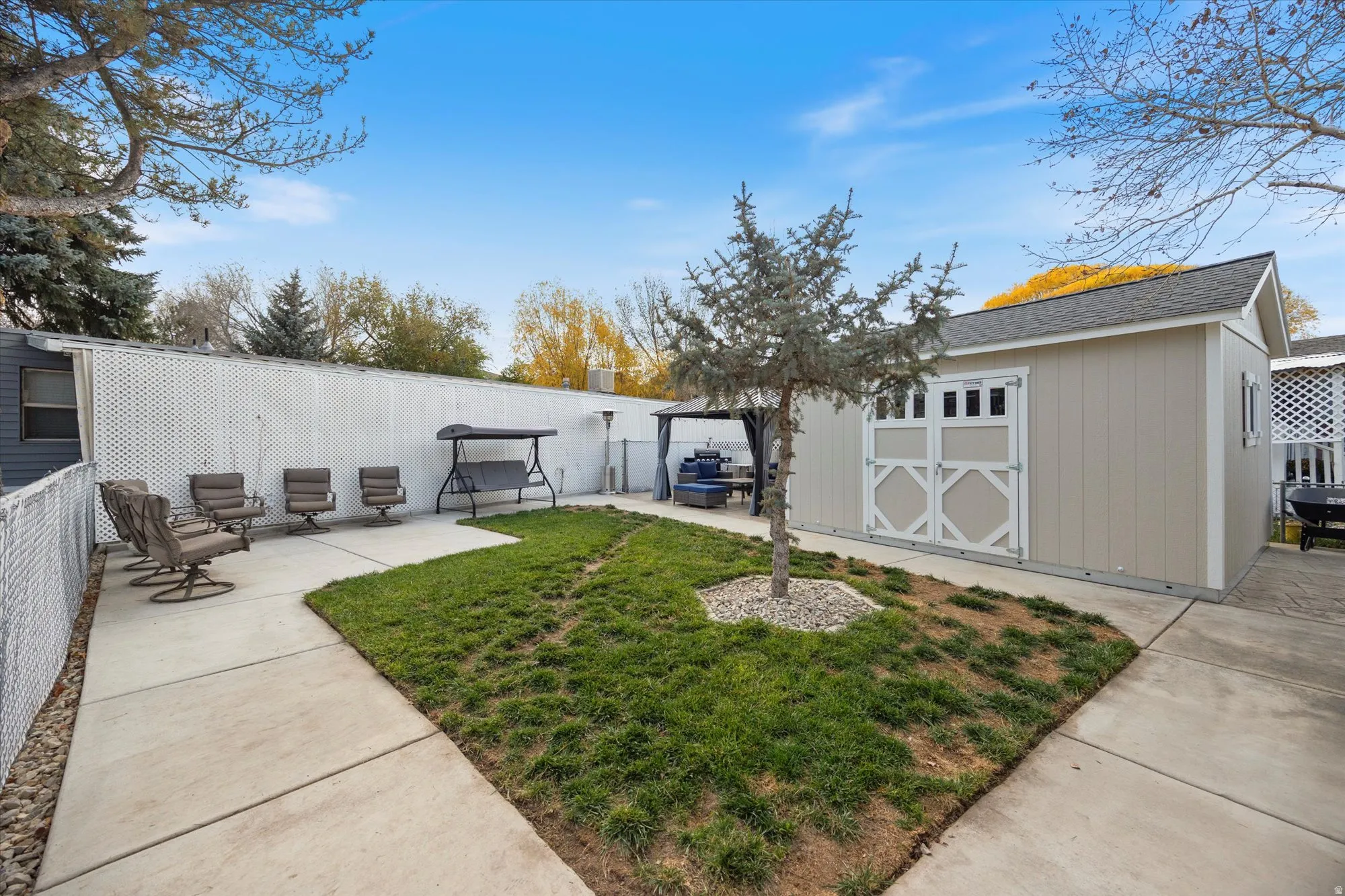 View of yard with a patio, an outdoor structure, and a gazebo