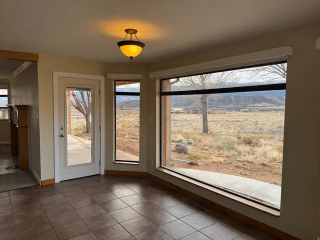 Unfurnished dining area with tile patterned flooring and a textured ceiling