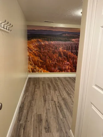 Storage room featuring wood finished floors and a textured ceiling