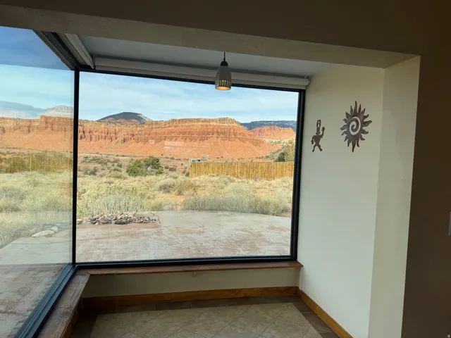 Sunroom with heated floors and floor to wall windows for viewing.