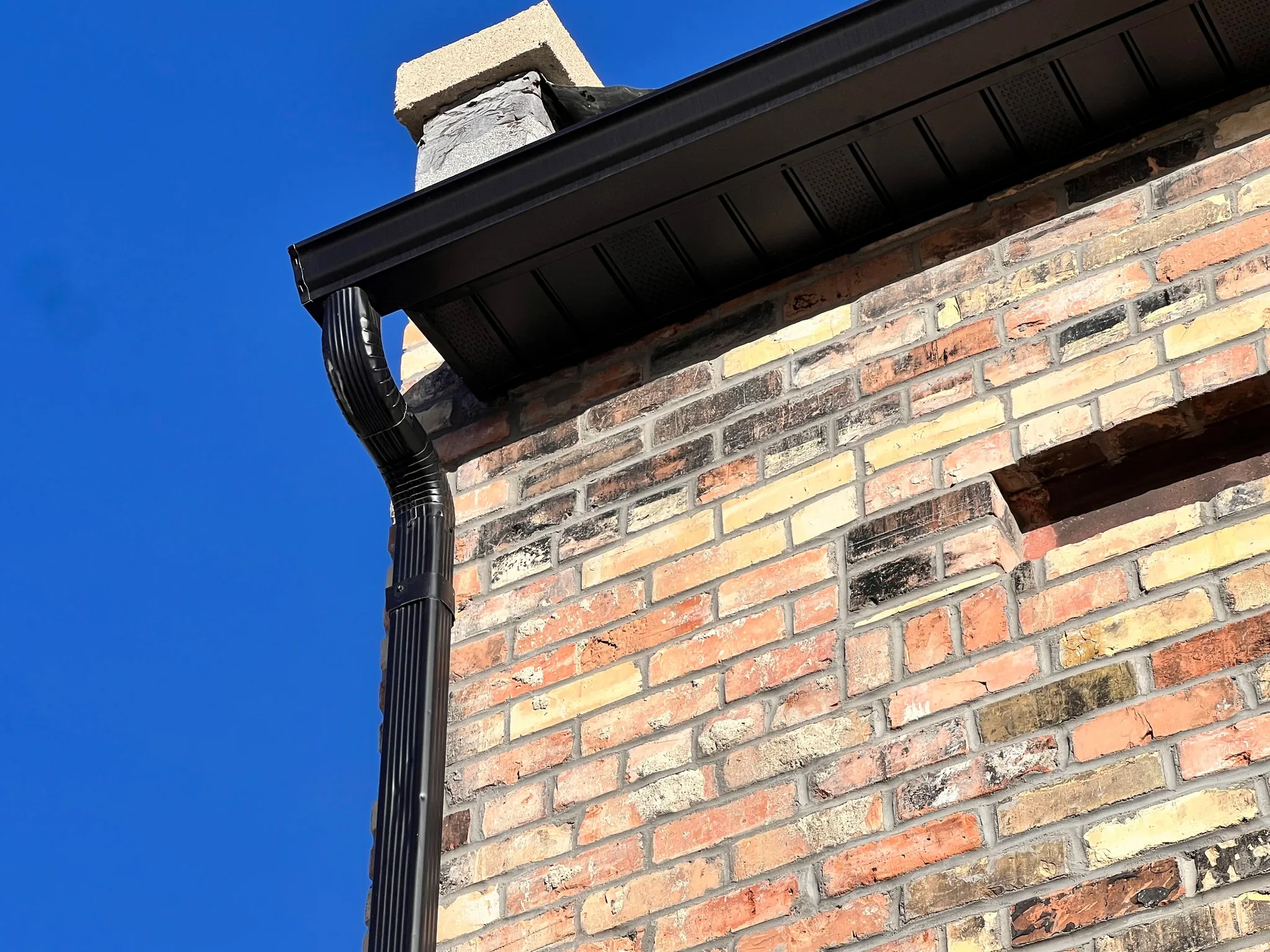 Exterior view of brick siding and new soffit and gutter.