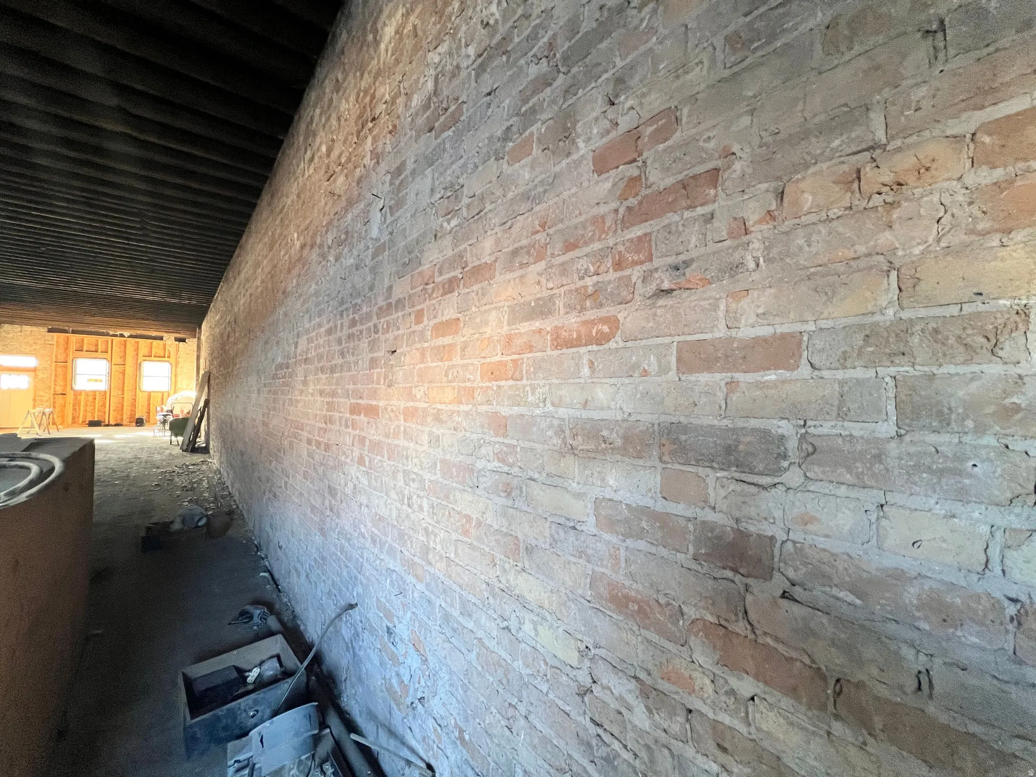 View of interior featuring brick siding and a patio