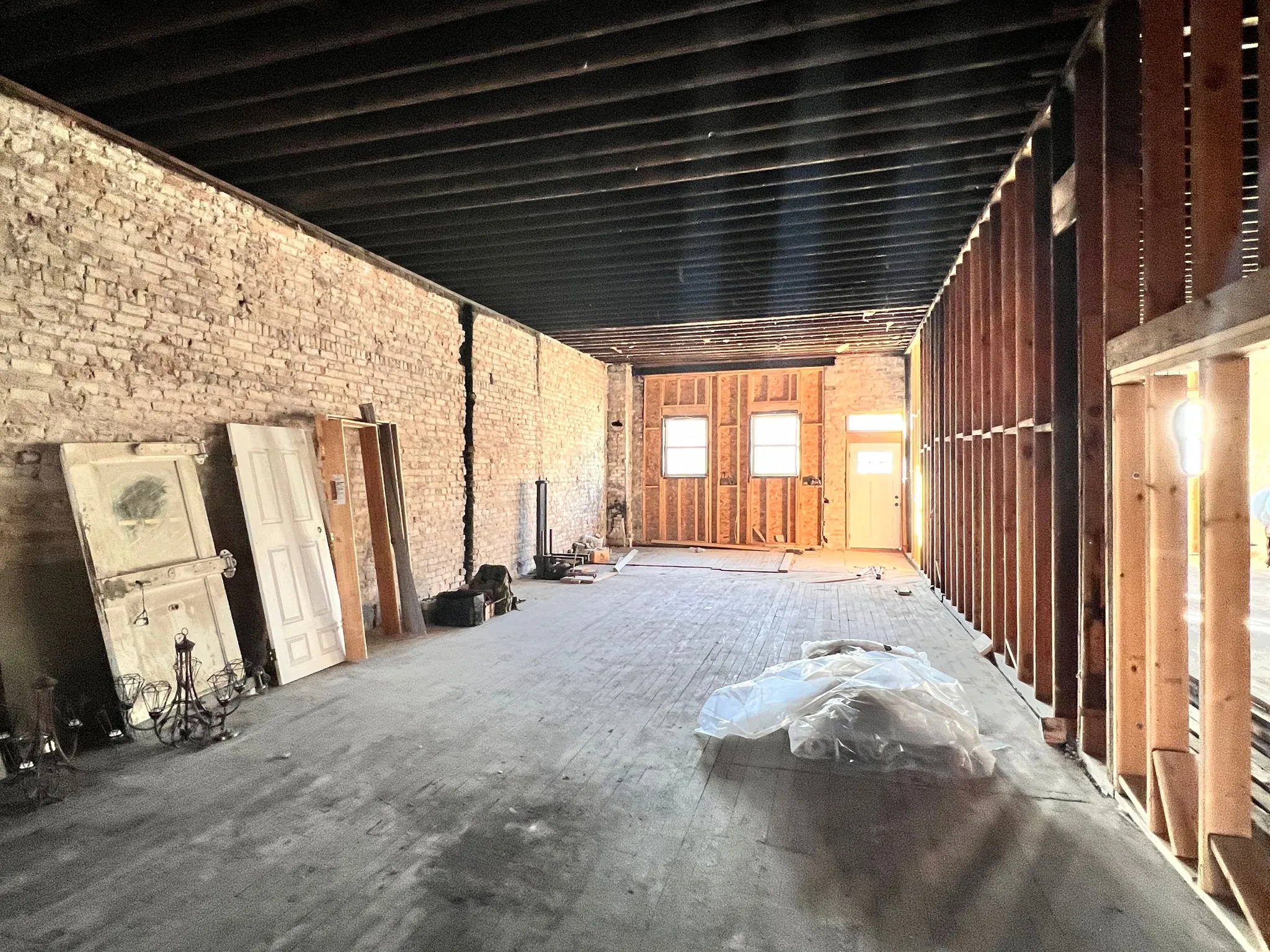 Misc room featuring brick wall and a garage
