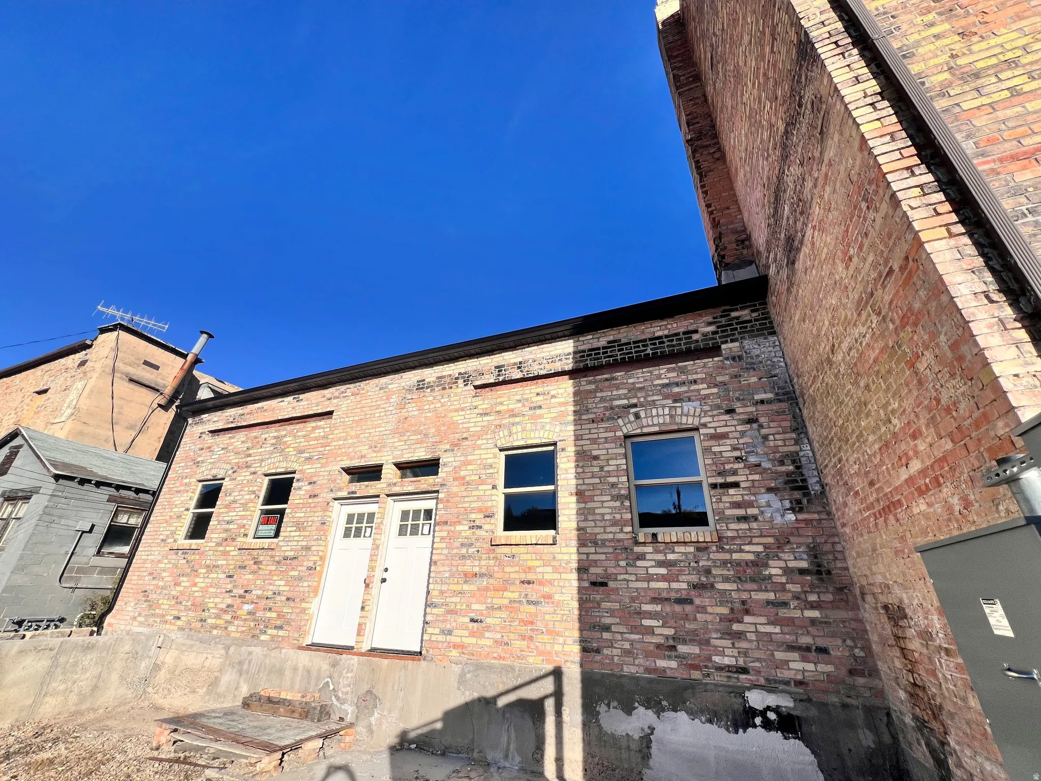 Back of property featuring brick siding