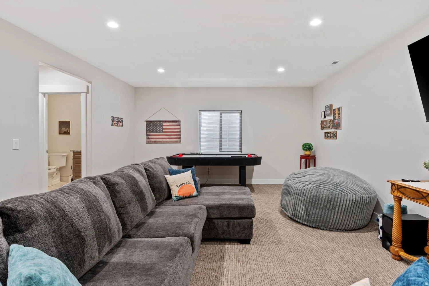Living room featuring light colored carpet and recessed lighting