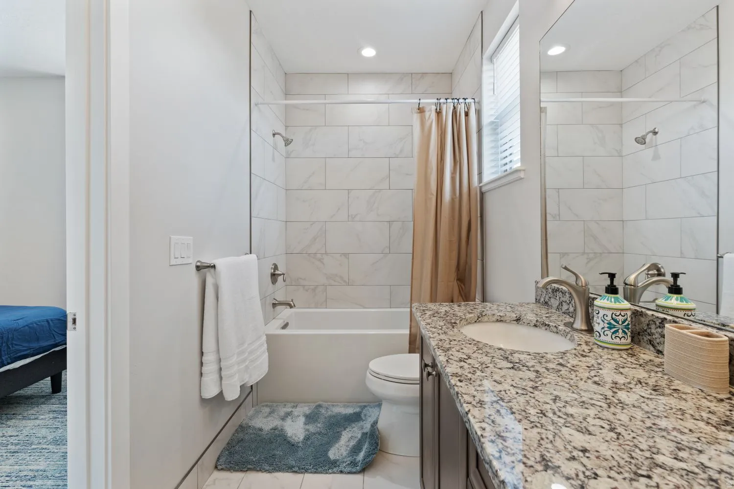 Bathroom featuring shower / bathtub combination with curtain and vanity