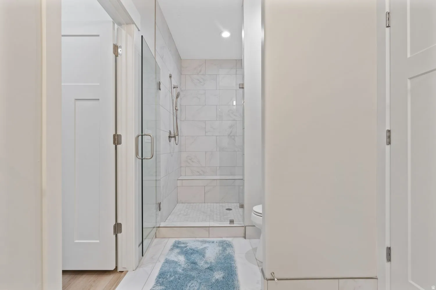 Full bathroom with a stall shower and toilet