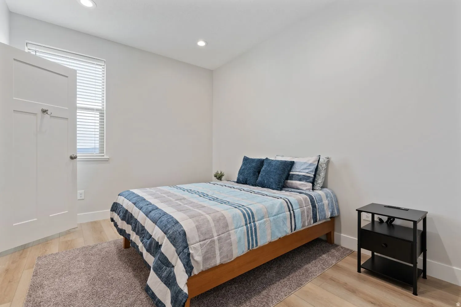 Bedroom featuring light wood finished floors and recessed lighting