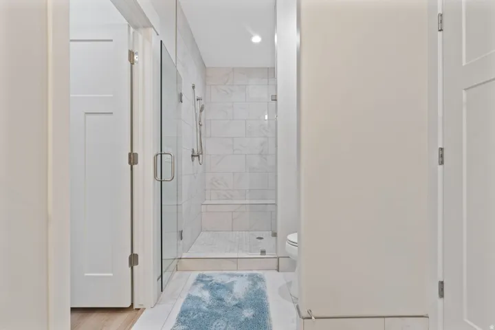 Full bathroom with a stall shower and toilet