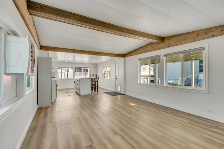 Unfurnished living room with light wood finished floors and baseboards