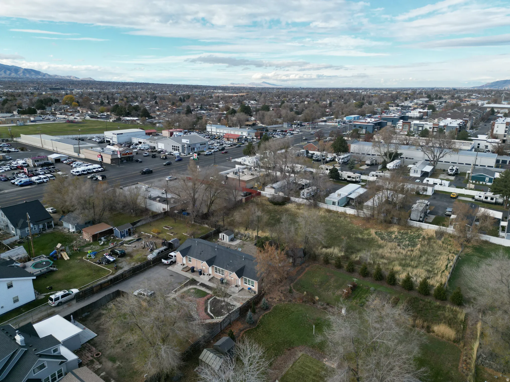 Aerial view of property and surrounding area with a mountain backdrop