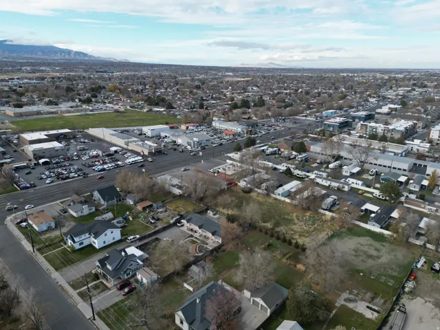 Aerial overview of property's location with a mountainous background and nearby suburban area