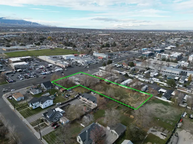 Aerial view of residential area featuring property boundaries highlighted and mountains