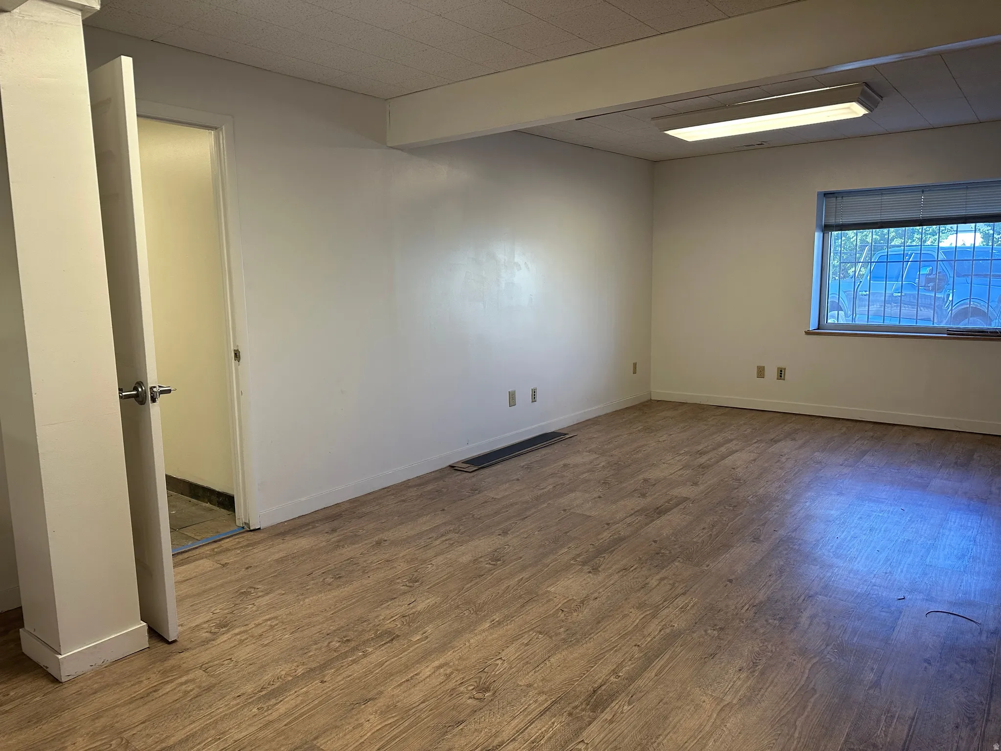 Unfurnished room featuring wood finished floors and baseboards