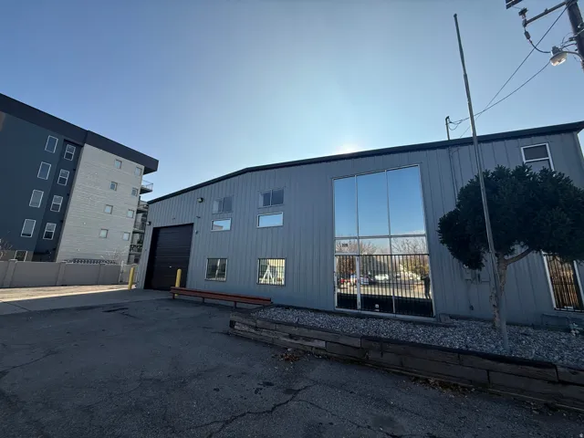 View of building exterior with driveway and a garage