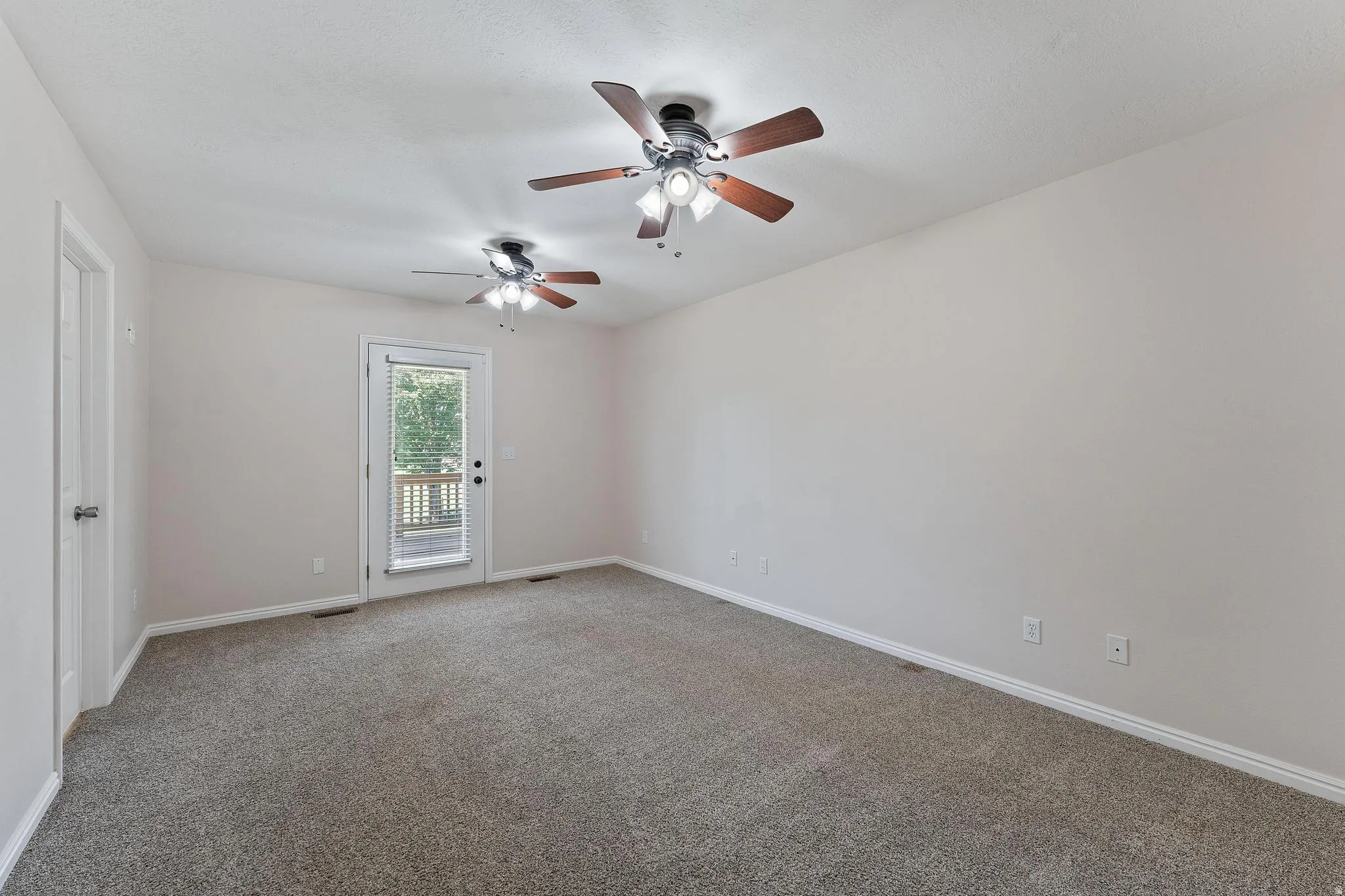 Spare room with light colored carpet and ceiling fan