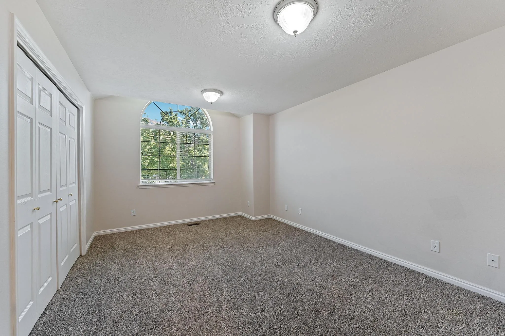 Unfurnished bedroom with carpet flooring, a closet, and a textured ceiling