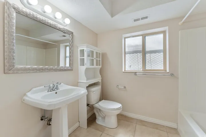 Full bathroom featuring light tile patterned flooring and shower / tub combination