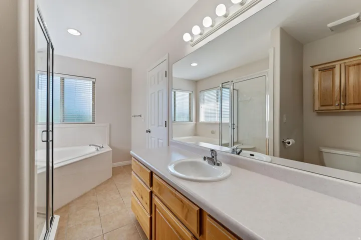 Bathroom featuring a garden tub, a shower stall, vanity, light tile patterned floors, and recessed lighting