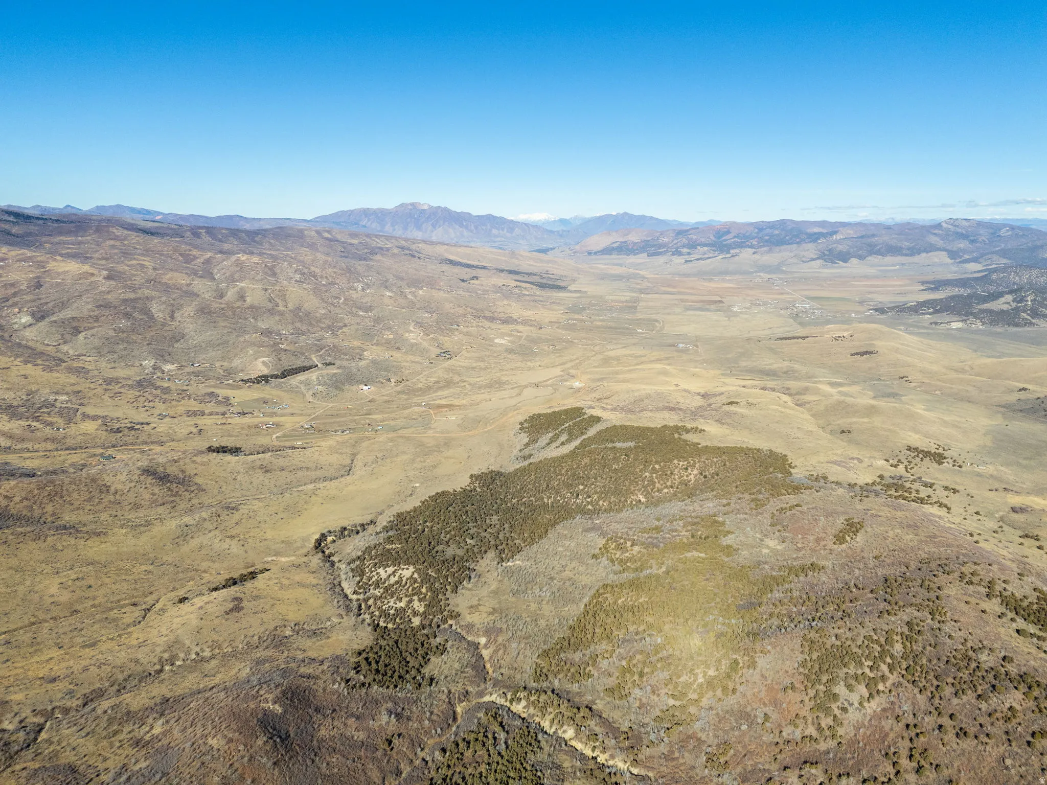 Aerial overview of property's location with a mountain backdrop and rural landscape