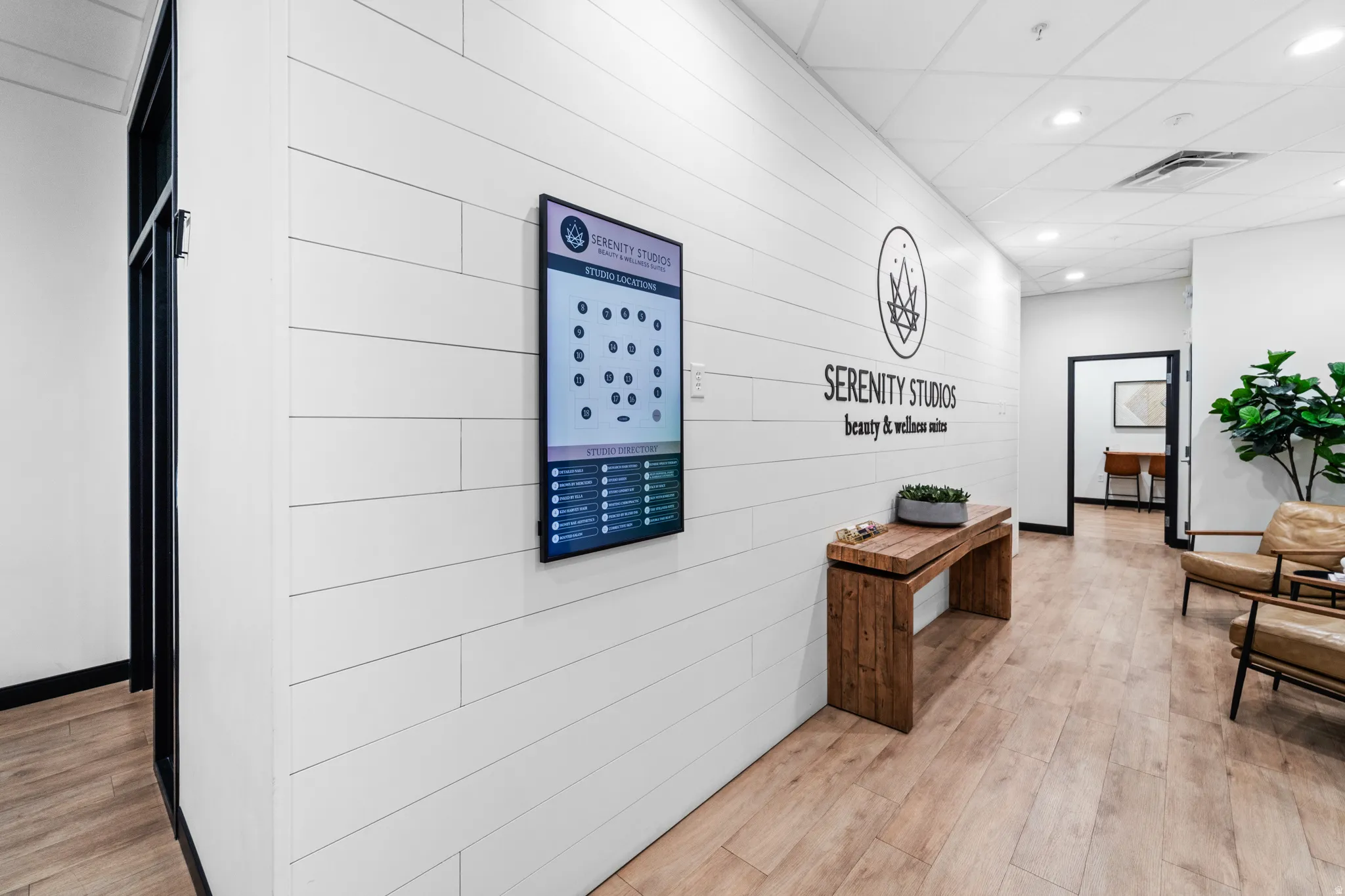 Corridor featuring light wood-style floors, a drop ceiling, and recessed lighting