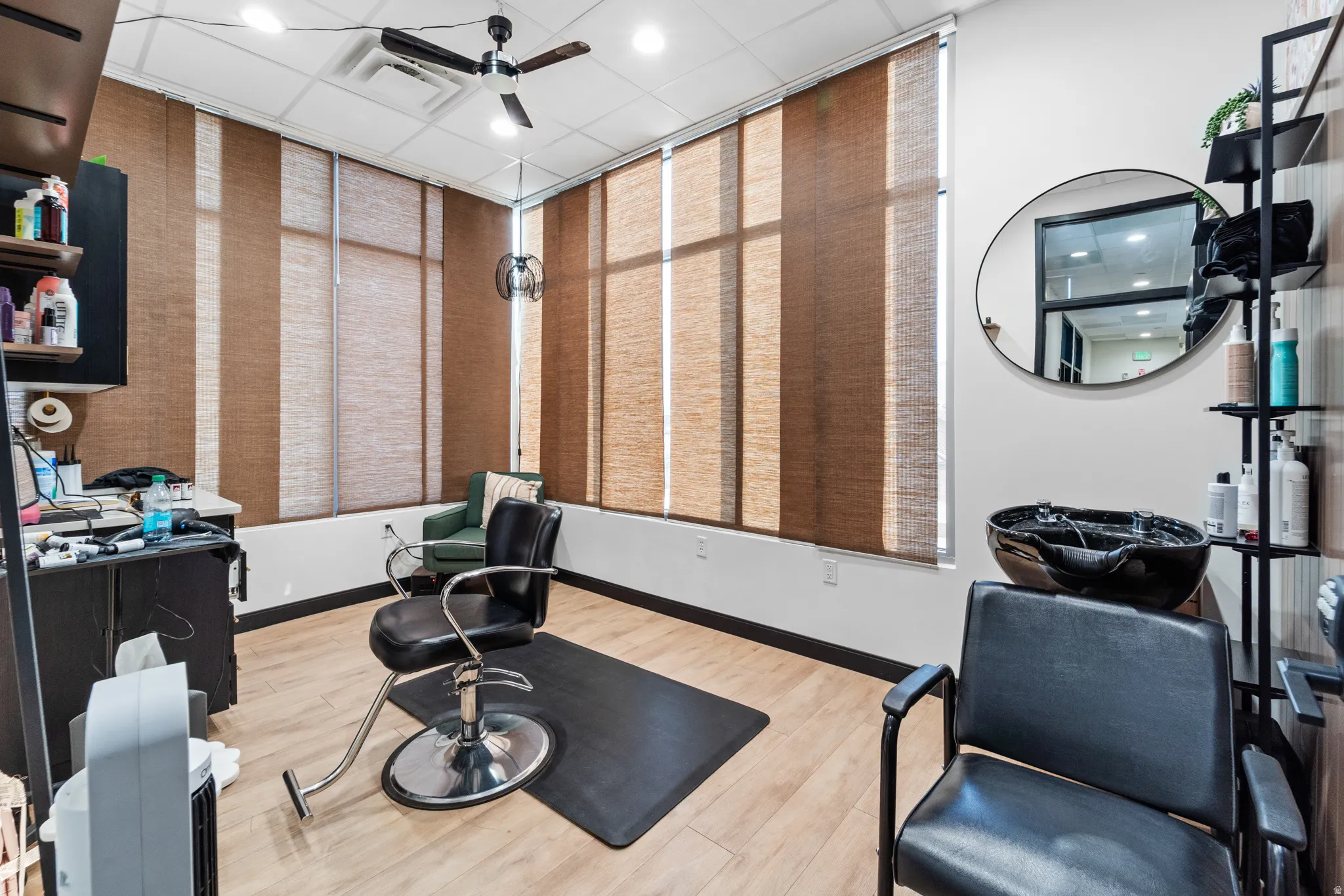 Exercise area featuring a ceiling fan, recessed lighting, and a drop ceiling