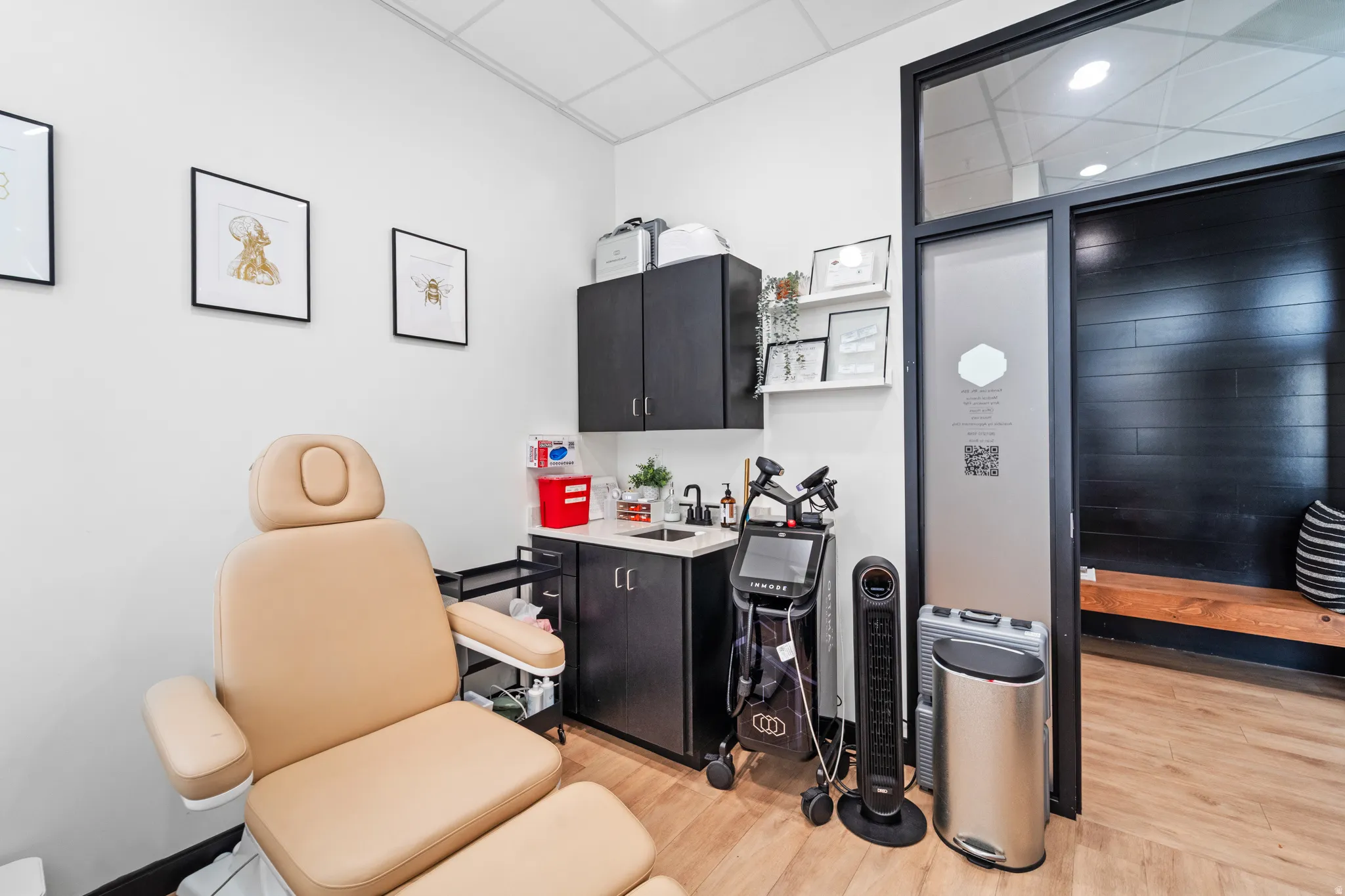 Miscellaneous room with a drop ceiling and a sink