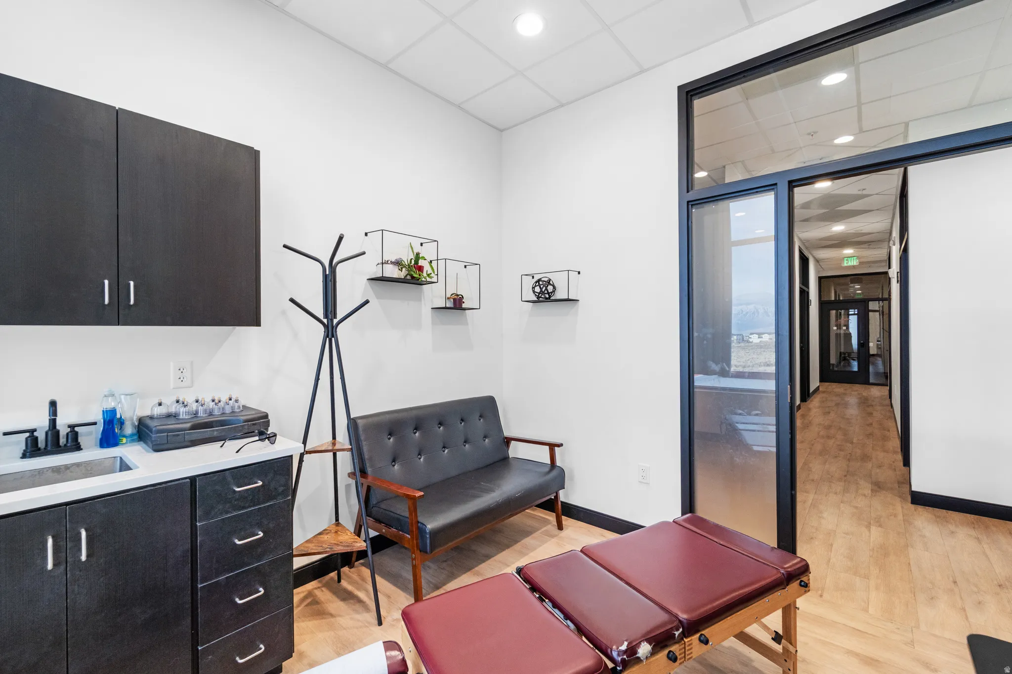 Misc room with a drop ceiling, light wood-type flooring, and recessed lighting