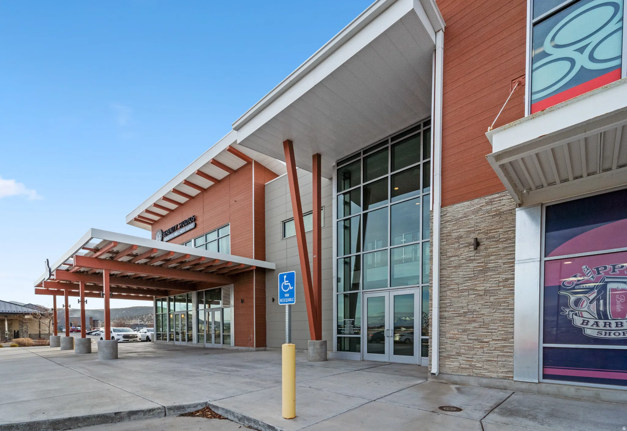 View of exterior entry featuring stone siding and french doors