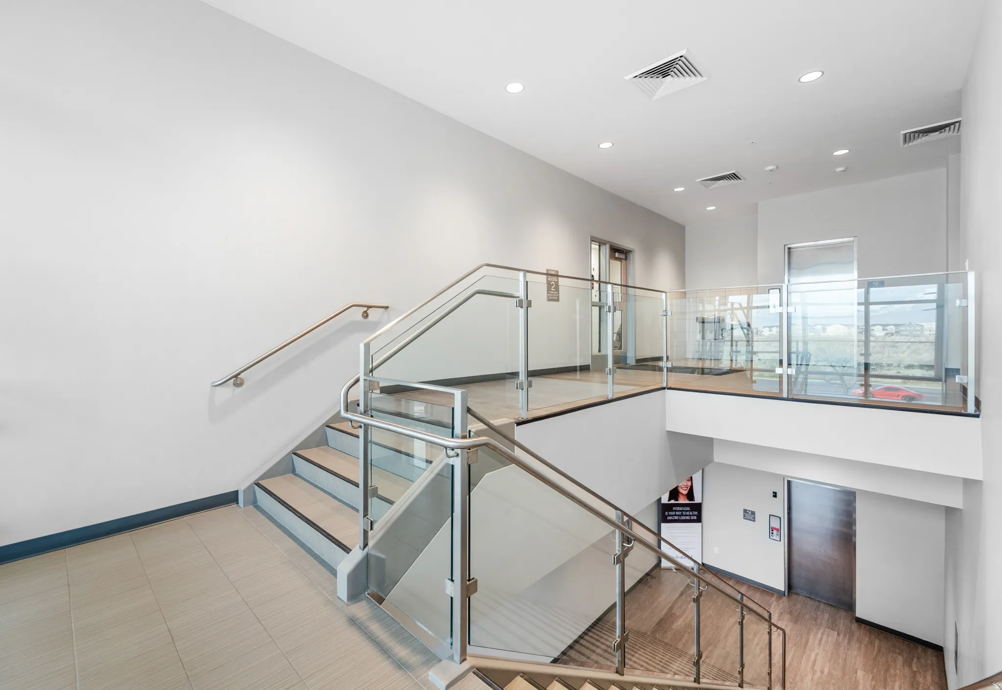 Staircase with recessed lighting and tile patterned floors