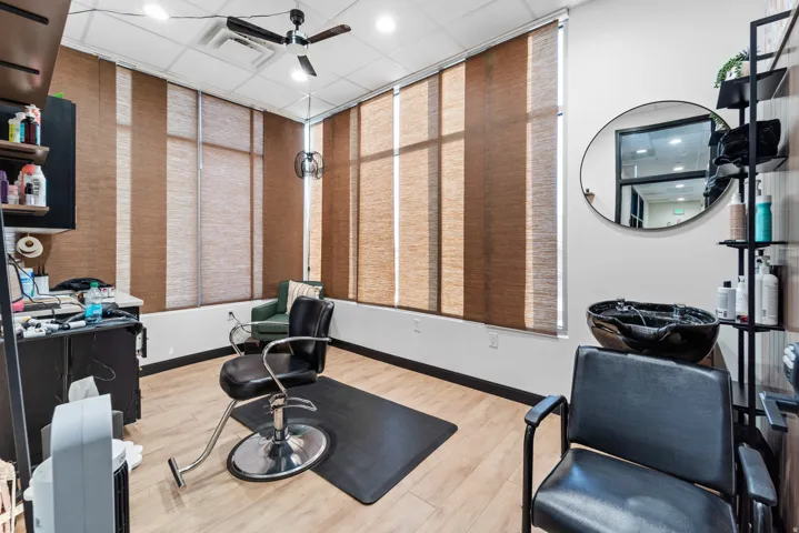 Exercise area featuring a ceiling fan, recessed lighting, and a drop ceiling