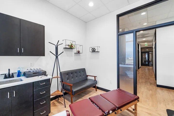 Misc room with a drop ceiling, light wood-type flooring, and recessed lighting