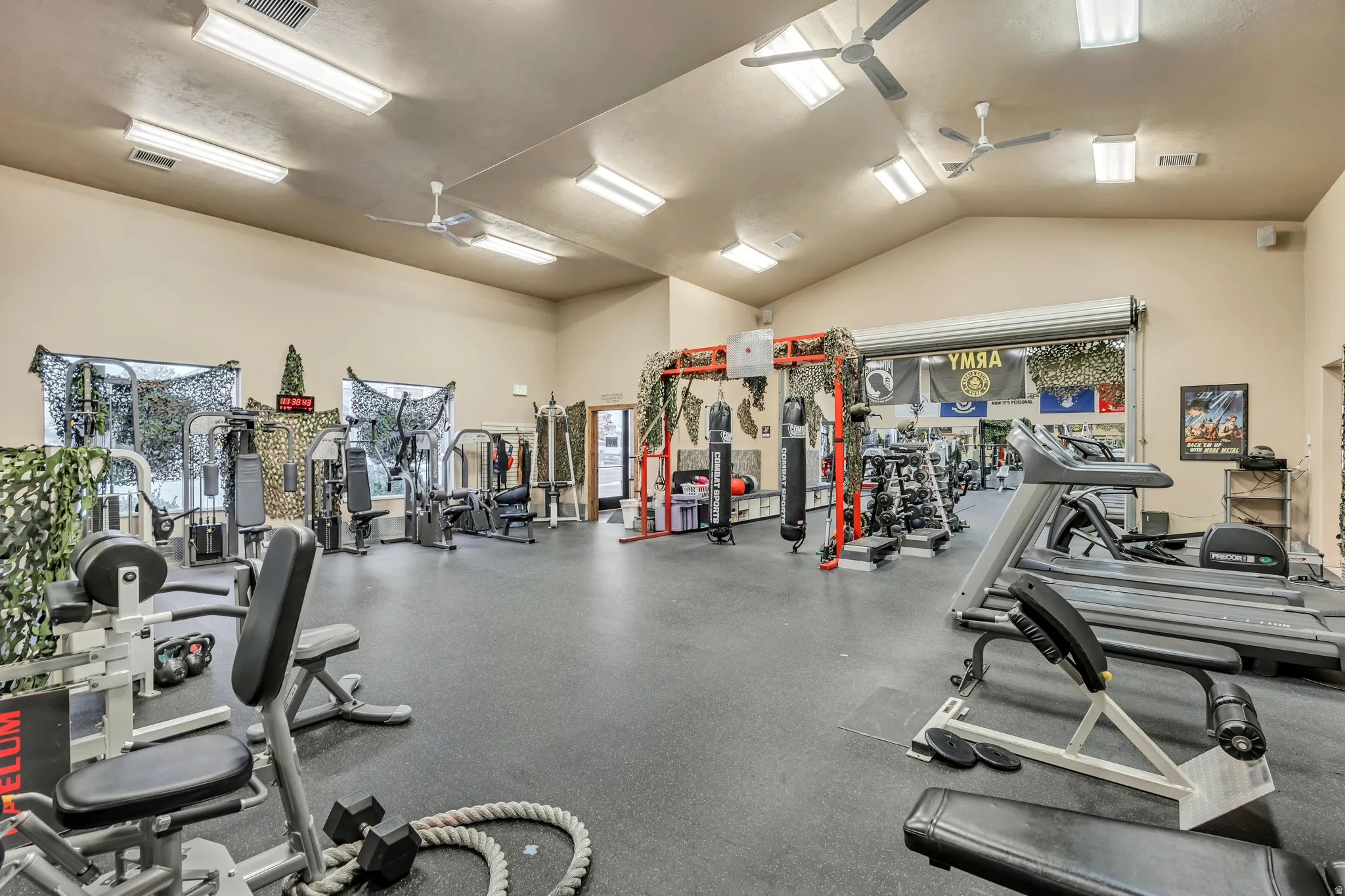 Gym with ceiling fan and vaulted ceiling