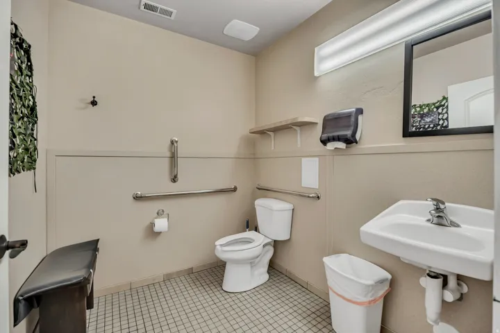 Half bathroom featuring toilet and tile patterned flooring