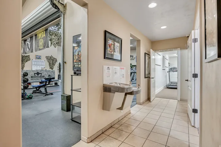 Hallway with light tile patterned floors and recessed lighting