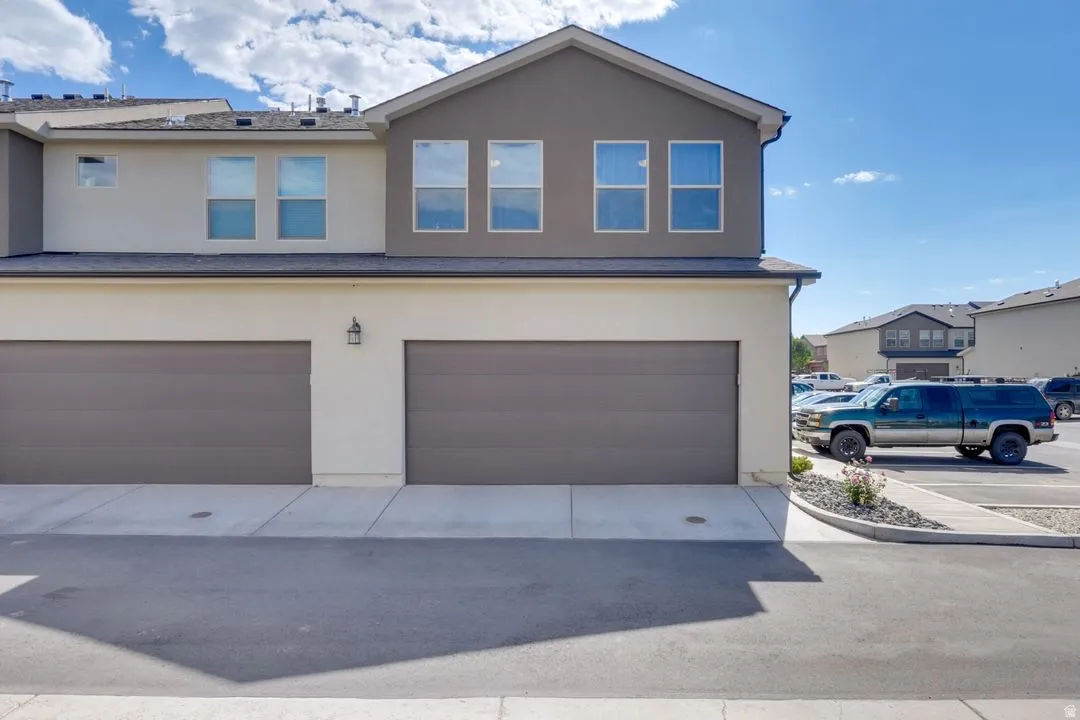 Traditional home featuring stucco siding and an attached garage